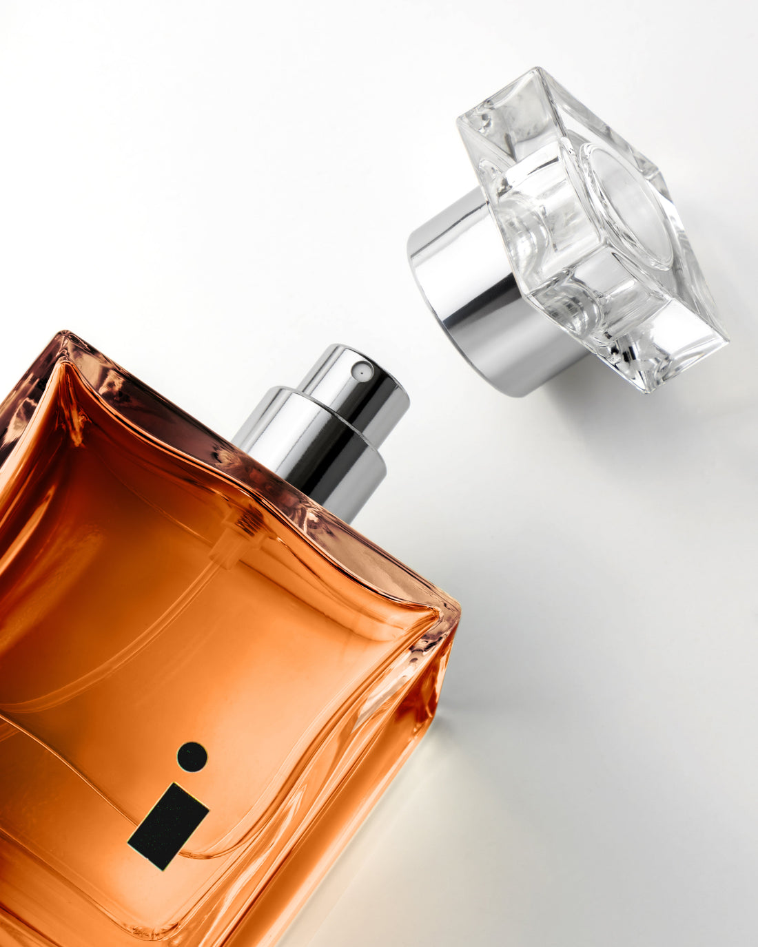 Black Oud eau de parfum 100ml — Illuminum London niche fragrance, amber glass bottle with cap removed